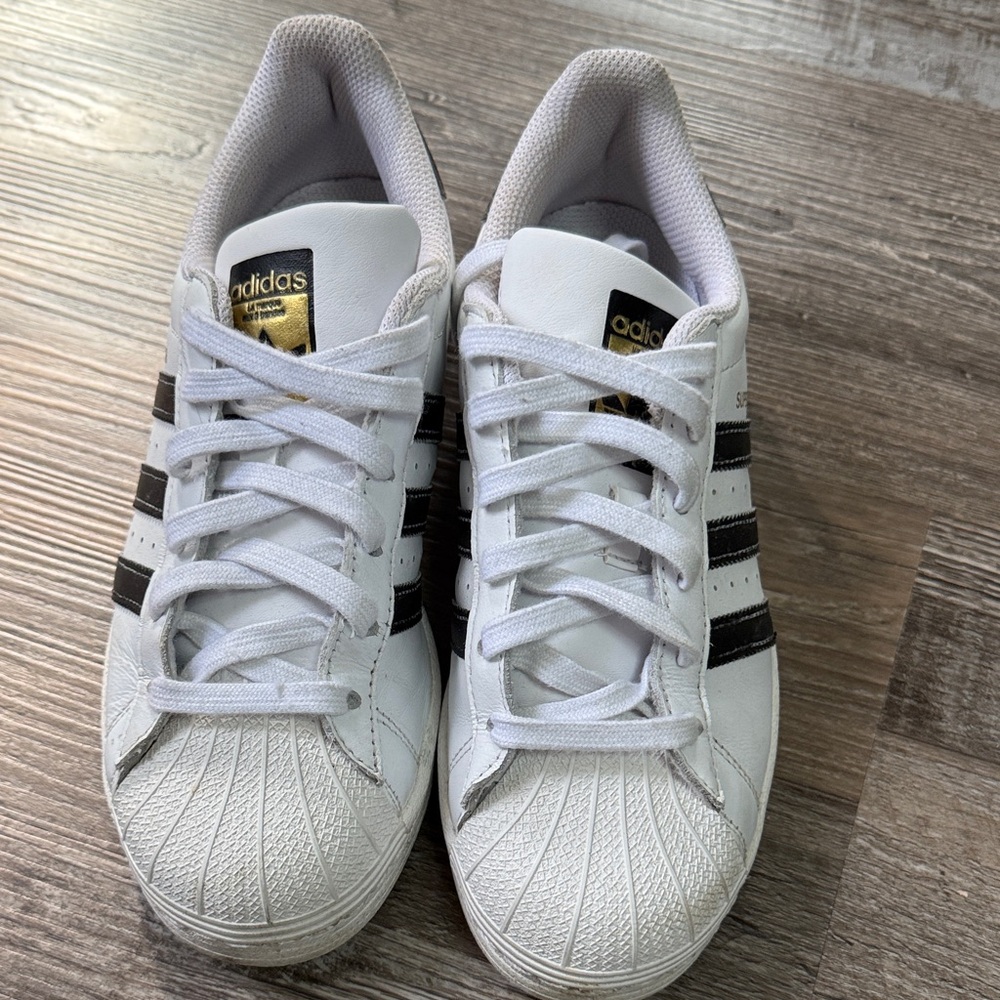 Adidas White Sneakers with Black Stripes and Gold Accents